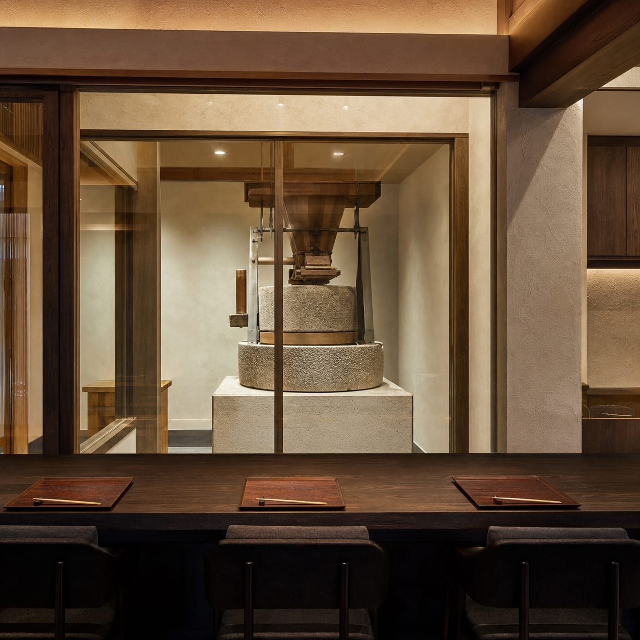 The milling room at Ishiusu to Mizu, seen through glass from the dining side