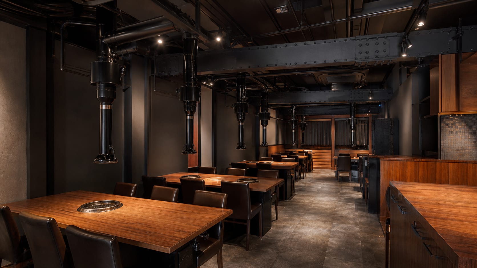 Ro to Hai. Extraction ducts routed beneath the exposed steel beams above 48 grill seats